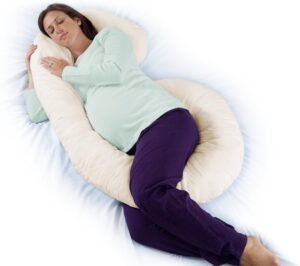 Almohada de cuerpo completo para embarazo y lactancia color blanco, sobre cama con decoración minimalista.